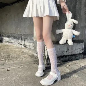 Detail view of Japanese Lolita white lace mid-calf socks paired with cute Mary Jane shoes.