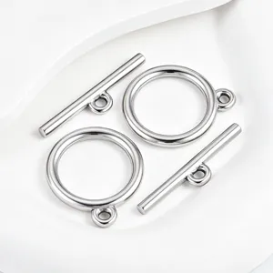 Close-up detail of polished stainless steel toggle clasp, smooth round ring and bar for DIY jewelry.