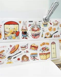 Close-up detail of cute rabbit and cake washi tape, decorative sticker for journaling.