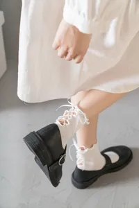 Süße japanische Damen-Mittelsocken mit feinen vertikalen Streifen und Schleife hinten.