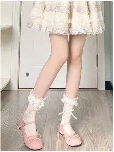 Detail view of sweet Japanese Lolita style white lace frilly socks with cute bowknot design.