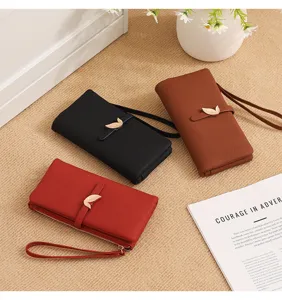 Detailed view of women long wallet with elegant leaf clasp and wrist strap in multiple colors.