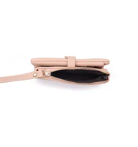 Pink short women wallet detail view showing zipper coin pocket and wrist strap design.