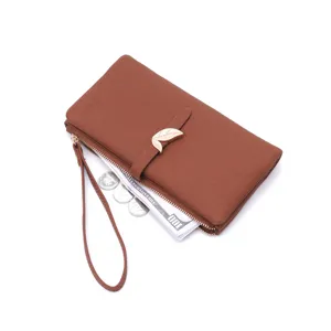 Close-up detail of the brown women's wallet featuring a chic metal leaf clasp and strap.