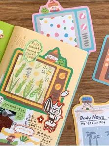 Close-up detail of cute oil pastel style sticky notes and memo pads for planner decoration.