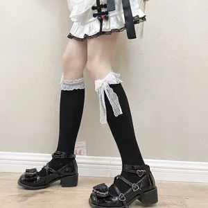 Detail shot of Japanese Lolita black knee-high socks featuring delicate white lace bow trim.