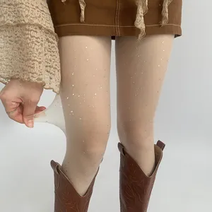 Detailed view of sheer glitter pantyhose showing stretchy elastic fabric with shiny star details.