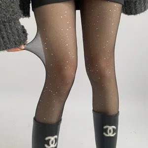Transparent black glitter pantyhose detail, shimmering sparkle sheer tights for women.