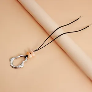 Chic irregular geometric hollow pendant necklace with marbled beads and soft black cord.