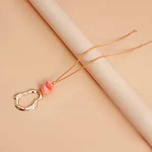 Chic irregular geometric hollow pendant necklace with pink marbled resin beads and soft suede cord.