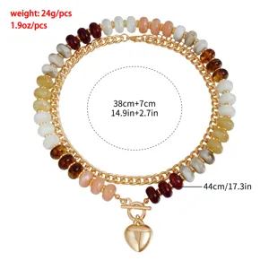Vista detallada de collar multicapa con cuentas de colores y cierre OT de corazón dorado.