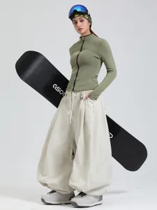 Professional waterproof loose wide leg snowboarding pants for women, windproof winter ski wear.