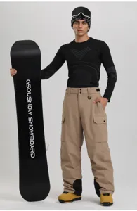 Detailed view of men's waterproof winter snow pants with a snowboard in a professional studio setup.