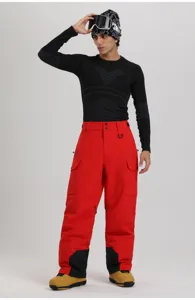 Men's red winter ski cargo pants detailed view, featuring durable windproof fabric and pockets.