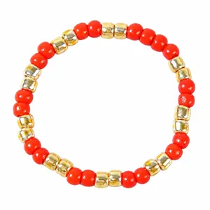 Red beaded bracelet with metallic gold spacer beads, stylish round beads single layer main view.