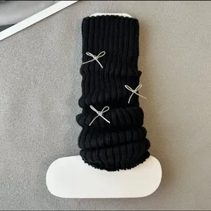 Black knit leg warmers with silver bows, Y2K Lolita style winter warm calf socks accessory detail.