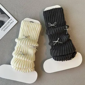 Close-up detail of knitted leg warmers with cute bows, soft texture, Y2K fashion style.