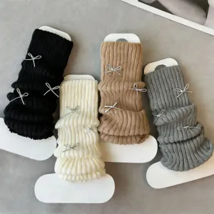 Knit leg warmers detail featuring cute bow accents, soft fabric texture, sweet JK style.