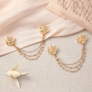 Gold rose clothing chain clips detail, elegant metal magnetic buttons for pants and cuffs.