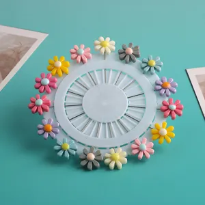 Colorful resin daisy long pin brooch set on round holder organizer for clothes accessories.