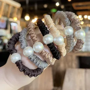 Elegant pearl satin hair scrunchies set, fashionable hair ties for women ponytail styling.
