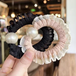 Chic pearl lace scrunchy hair tie for women, elegant fabric ponytail holder fashion accessory.
