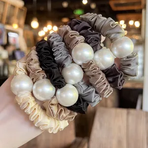 Elegant satin hair scrunchies with large pearls, soft elastic hair ties for women and girls styling.
