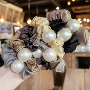 Elegant satin pearl scrunchie set for women, fashionable hair tie accessory for ponytails.