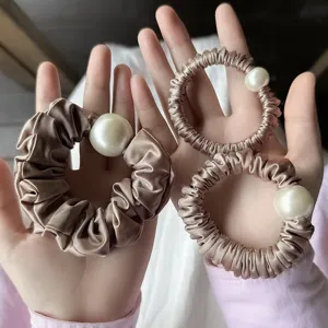 Elegant champagne satin hair scrunchies with large pearl charm for women daily styling.