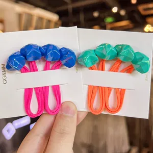 Detailed shot of Korean fluorescent colorful faceted star hair ties, cute kids cartoon hair accessories.