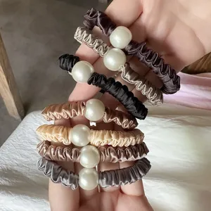 Satin pearl scrunchies for women, elegant hair ties and ponytail holders for daily wear.