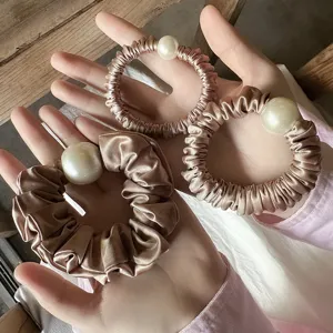 Elegant satin pearl hair scrunchies for women, soft silk ponytail holder hair accessories.