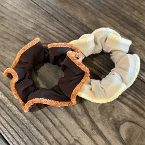 Velvet hair scrunchie detail view, elegant ruffled design, premium autumn winter hair accessories.