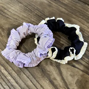 Detailed view of pleated satin hair scrunchies, featuring elegant ruffled edge design.