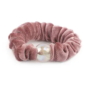 Close up detail of dusty pink velvet hair scrunchie with sparkling glitter bead accent.