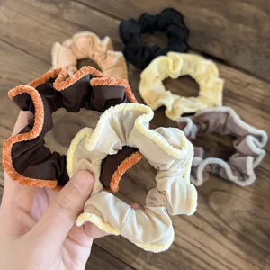 Detailed view of autumn winter vintage velvet scrunchies with lace trim for charming hairstyles.