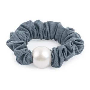 Grey textured fabric hair scrunchie detail shot featuring a large central white pearl accent.