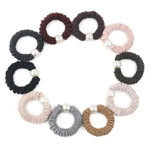 Detail shot of multi-color woolen scrunchies featuring elegant large faux pearls for daily hair.