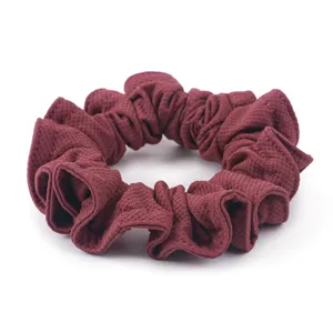 Close-up of wine red honeycomb ice silk hair scrunchie, detailed textured fabric texture.