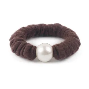 Brown wool scrunchie detail with white pearl, elegant autumn winter hair accessory.