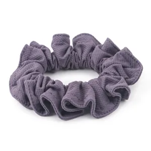 Detailed shot of purple ice silk hair scrunchie with ruffled design for elegant daily hairstyles.