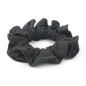 Detailed view of a black honeycomb ice silk hair scrunchie showing fine fabric texture.