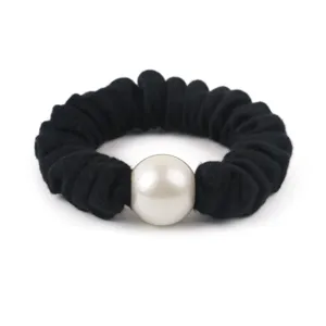 Detail view of black wool scrunchie with large white pearl hair accessory for women.