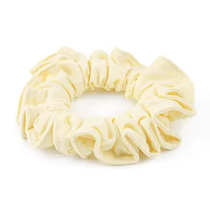 Yellow honeycomb ice silk scrunchie detail view, soft and stretchy fabric hair tie for daily use.