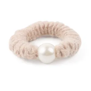 Close-up detail of a chic beige wool scrunchie with large faux pearl for elegant hairstyles.