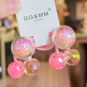 Close-up detail of colorful disco ball hair ties, sparkling faceted beads with elastic band.