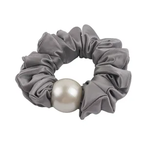 Elegant grey satin hair scrunchie with large pearl detail, perfect for chic ponytails.