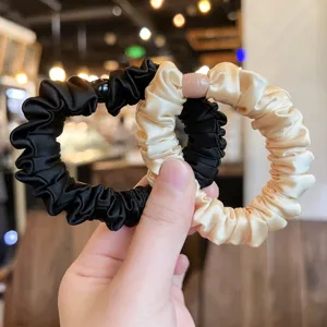 Detail shot of elegant satin hair scrunchies, high elasticity ponytail holder accessories.