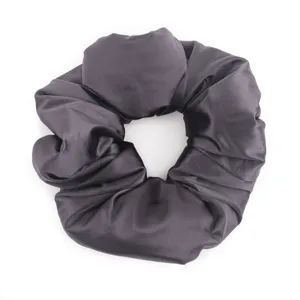 Dark grey satin stuffed hair scrunchie detail shot, soft fabric and fluffy design texture.