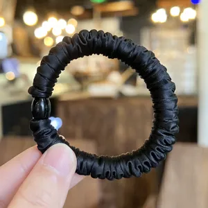 Black satin hair scrunchie with cute round bead detail, high elastic ponytail holder accessory.